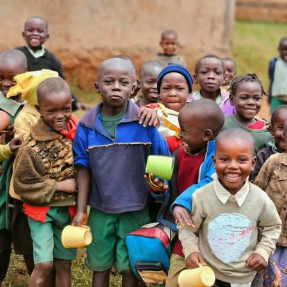 Children gathered at a Lishe Kwa Mtoto community feeding event