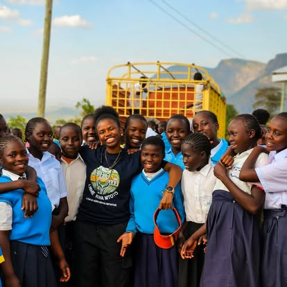 A BintiCare team member with students supported by the program