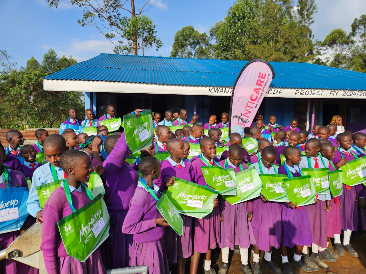 Scholars proudly holding their new bags