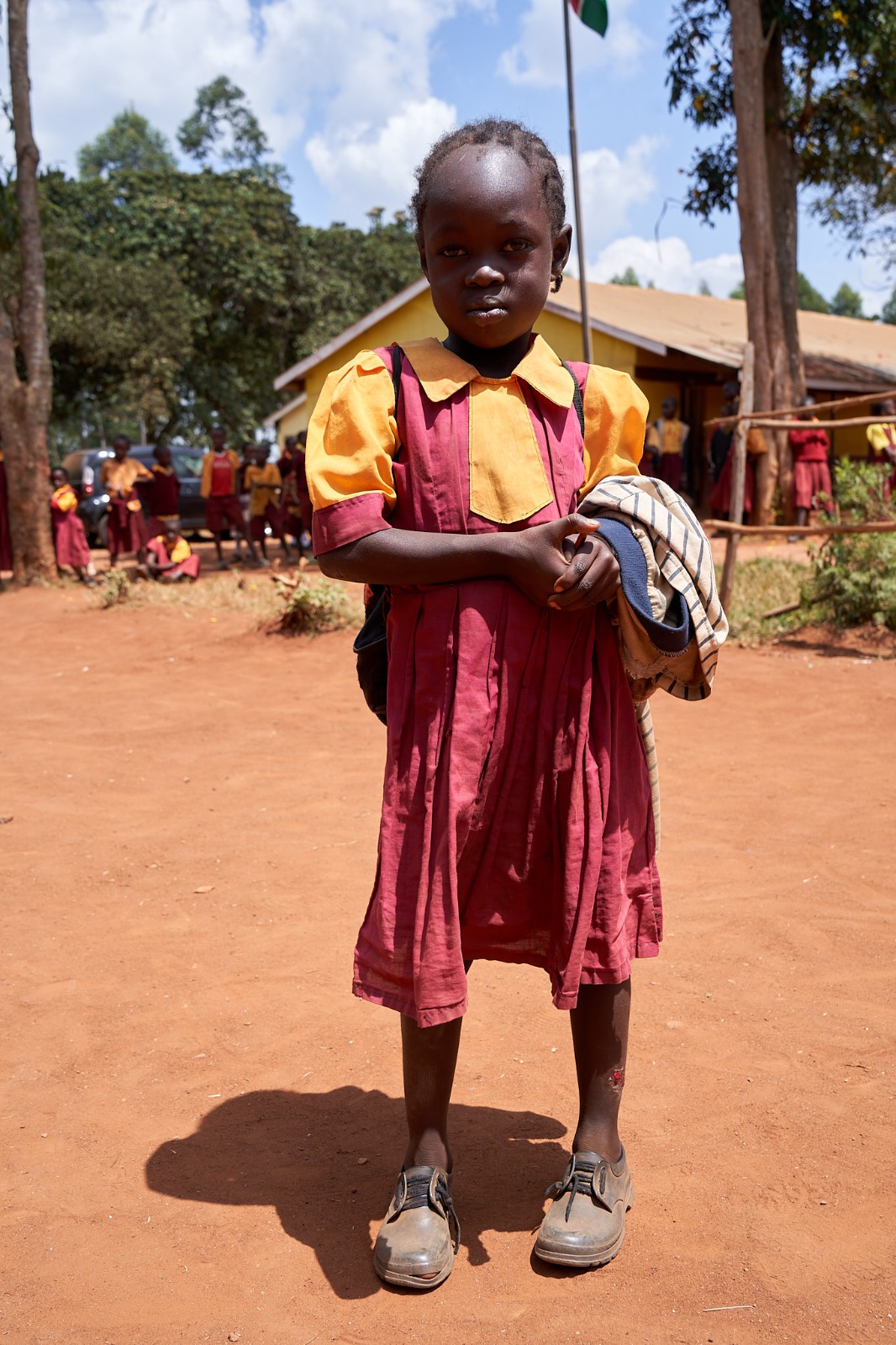 Before: a learner carrying spare clothing to school